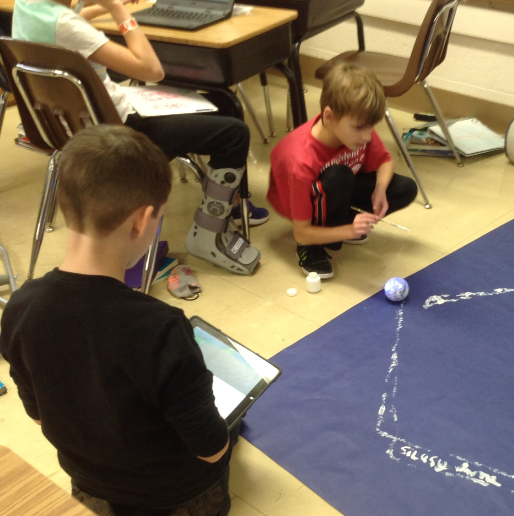students working on coding shapes